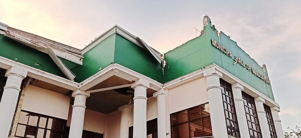 Quake aftermath. The municipal hall of Magsaysay in Davao del Sur sustained damage from the magnitude 6.3 quake that rocked Mindanao on Wednesday night. Inset is one of the damaged houses in Kidapawan, North Cotabato. PHOTOS BY ANTHONY ALLADA AND RHODERICK BEÑEZ