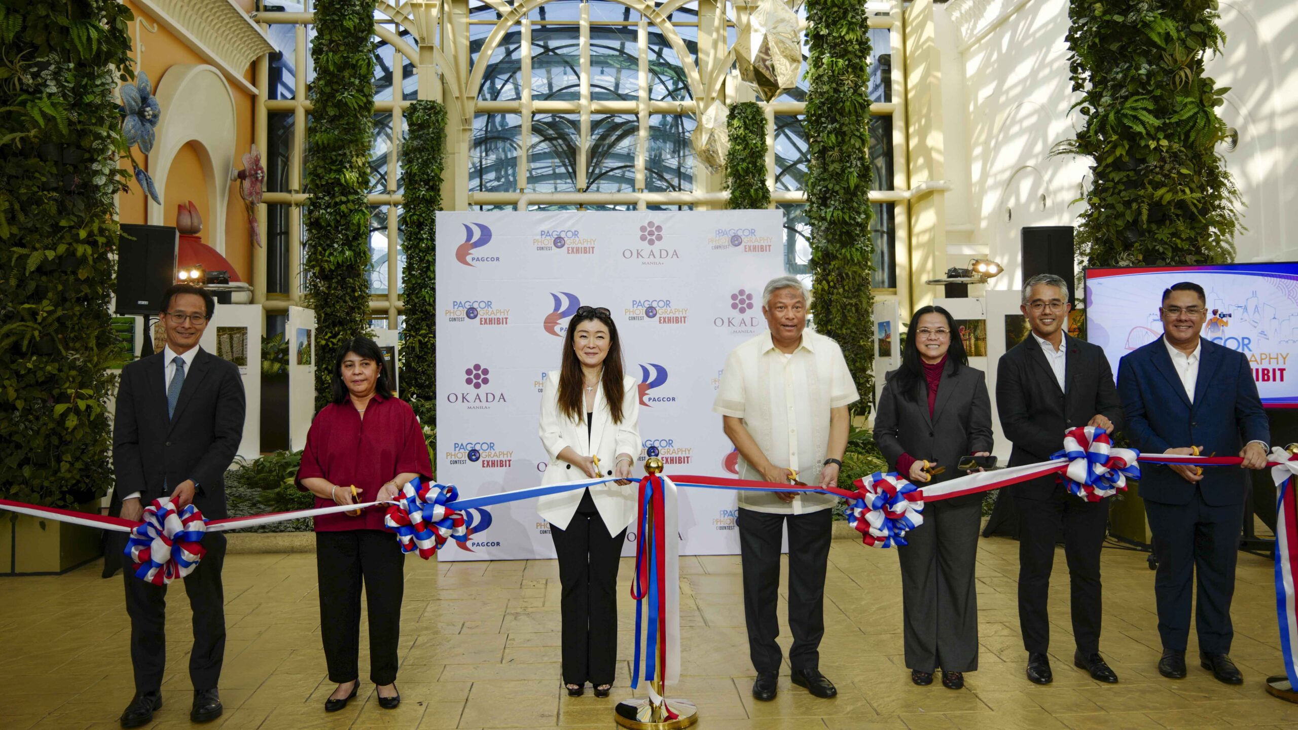 PAGCOR Chairman and CEO Alejandro H. Tengco (4th from right) and Okada Manila Co-Vice Chairperson Mrs. Takako Okada (5th from right) lead the ribbon-cutting for the PAGCOR Photography Contest Exhibit at Okada Fountain Foyer in Parañaque City. With them are (from right) PAGCOR Directors Francis C. Concordia, and Gilbert Cesar C. Remulla, President and COO Wilma T. Eisma, and Okada Manila Co-Vice Chairperson Atty. Michelle Lazaro and President and COO Byron Yip