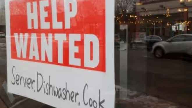 A “Help Wanted” sign hangs in restaurant window in Medford, Massachusetts, US. (Reuters Photo)