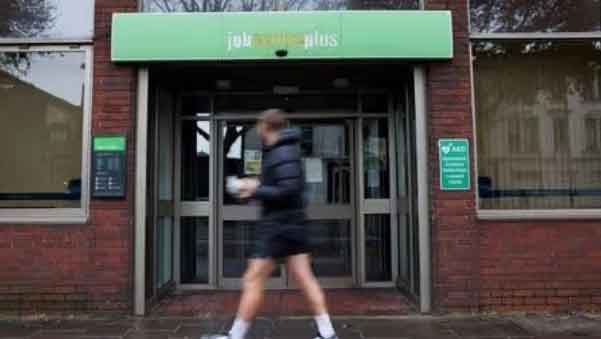 A passer-by walks past a job center in Borough, in London, Britain. (Reuters Photo)